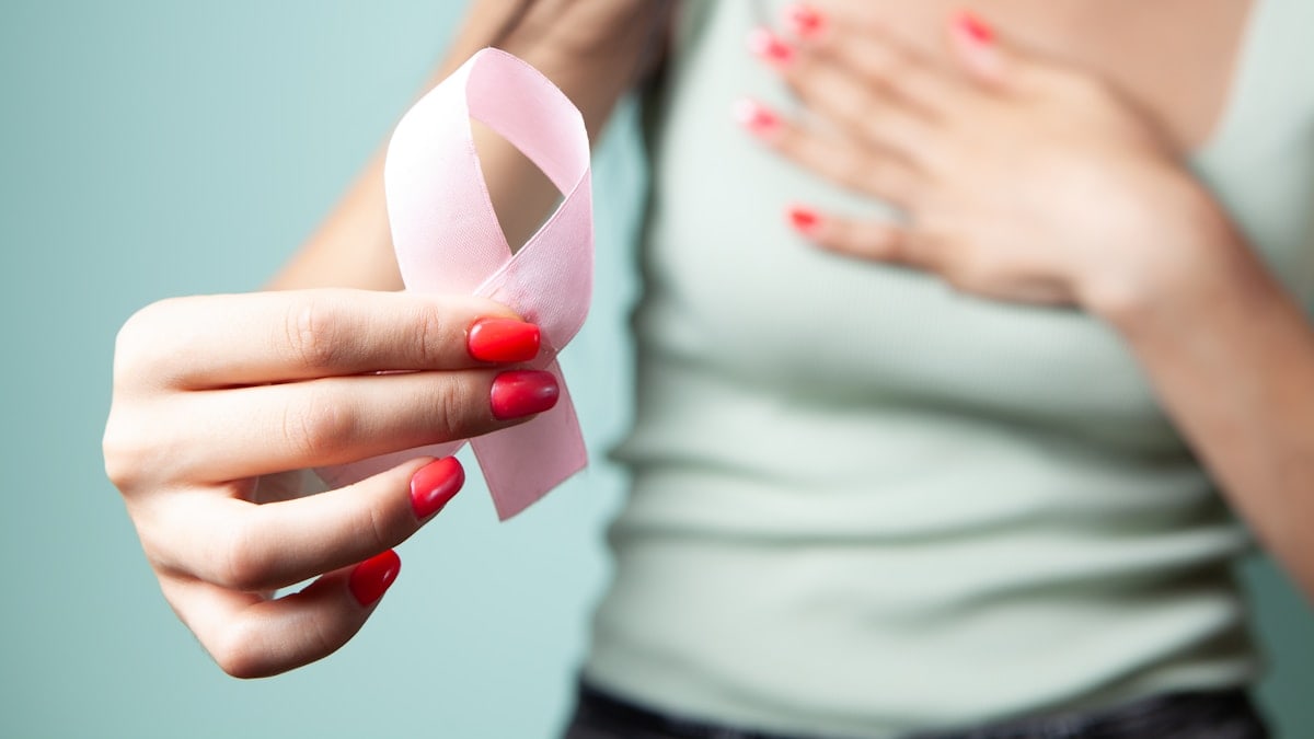 woman with pink ribbon and breast cancer awareness